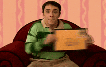 A gif of Steve from &quot;Blue&#x27;s Clues&quot; sitting and dancing while holding an envelope 