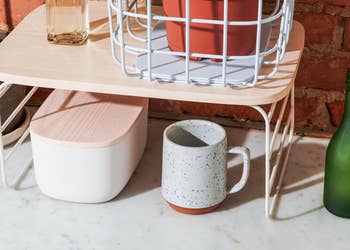 The shelf riser over a mug and storage container