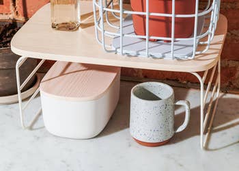The shelf riser over a mug and storage container