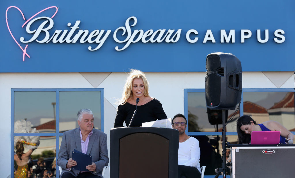 Britney speaking in front of the Britney Spears Campus