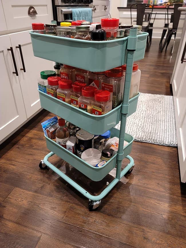 A reviewer using the aqua utility cart to hold pantry items