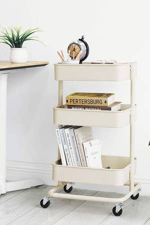 The white utility cart holding office supplies