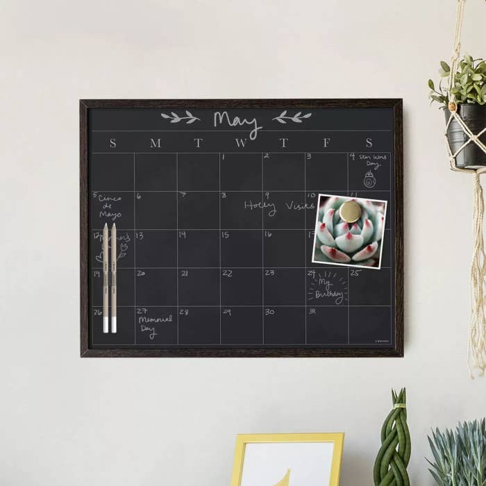 The calendar with its pens hanging on a wall