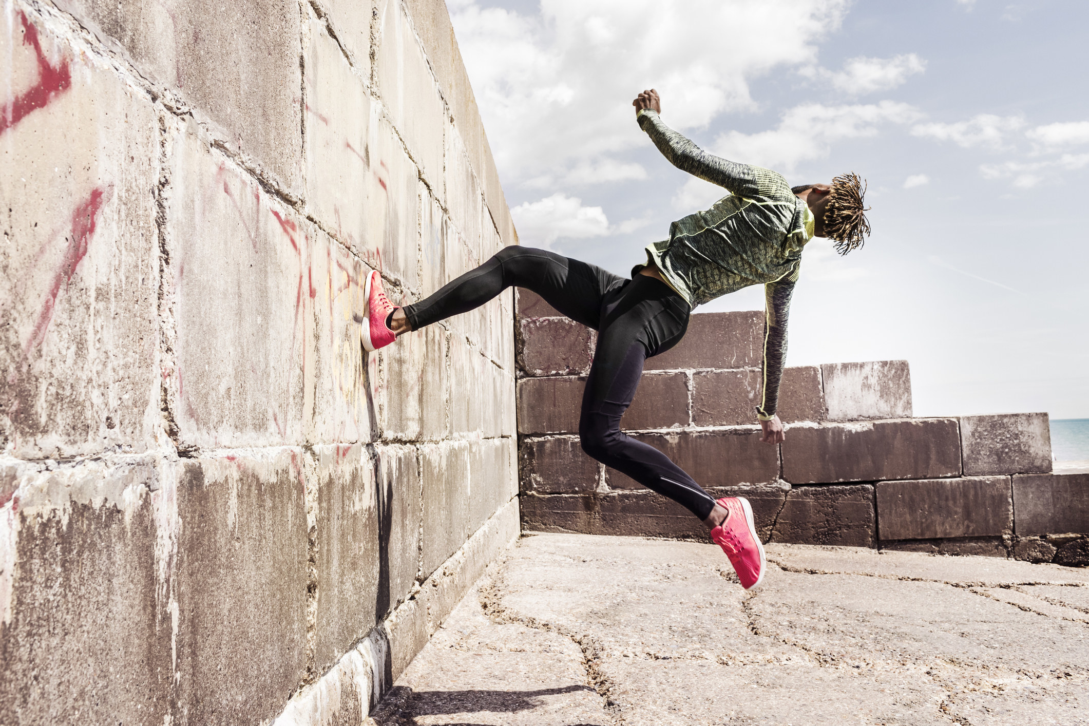 Young man running up side of wall
