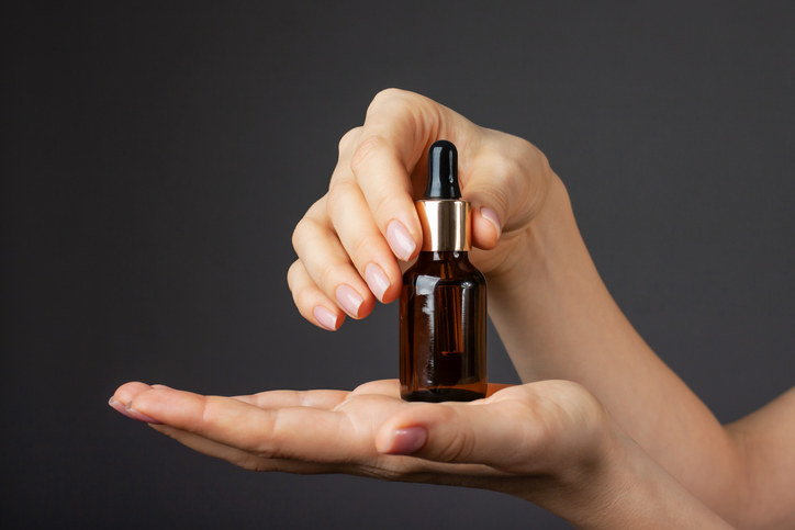 a woman holding a serum