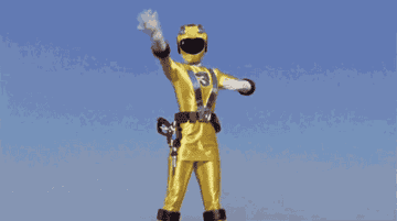 A yellow Power Ranger making hand movements with an explosion in the background so it looks like they&#x27;re farting