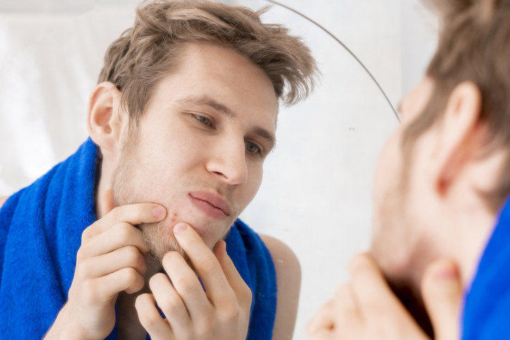 a man popping a pimple