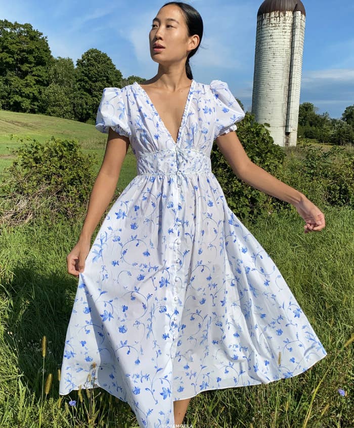 a model walks in a field wearing the opaque sabrina nap dress