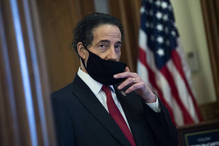 Jamie Raskin pulls down a face mask