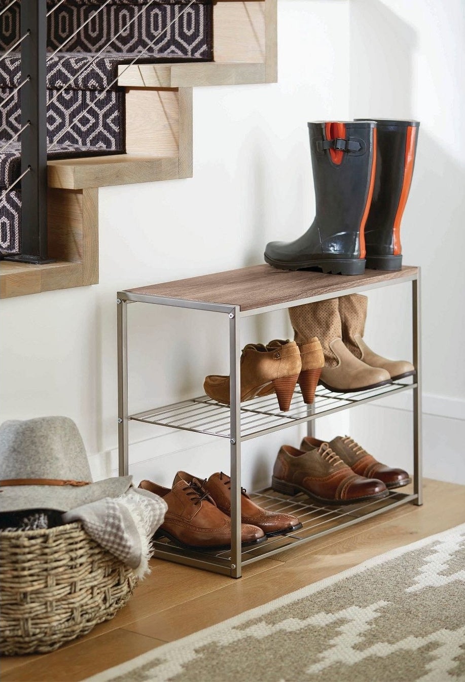 The rack, which has open two wire shelves, and is topped with a solid wood-finish shelf