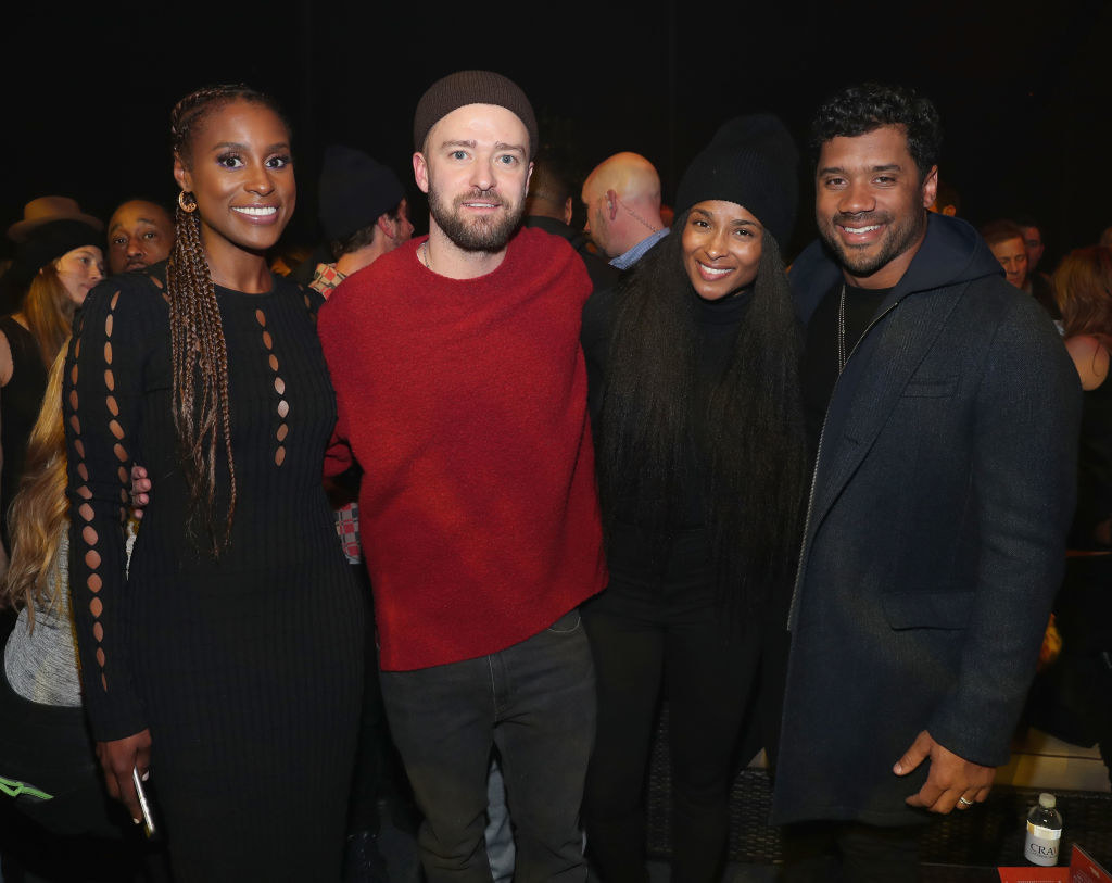 Issa Rae, Justin Timberlake, Ciara, and Russell Wilson posing for a picture 