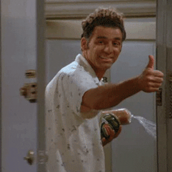 a gif of kramer giving a thumbs up while walking out a door