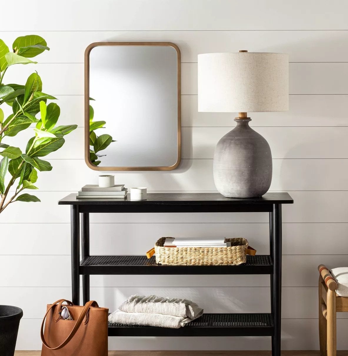 The rectangular mirror in an entryway above a table