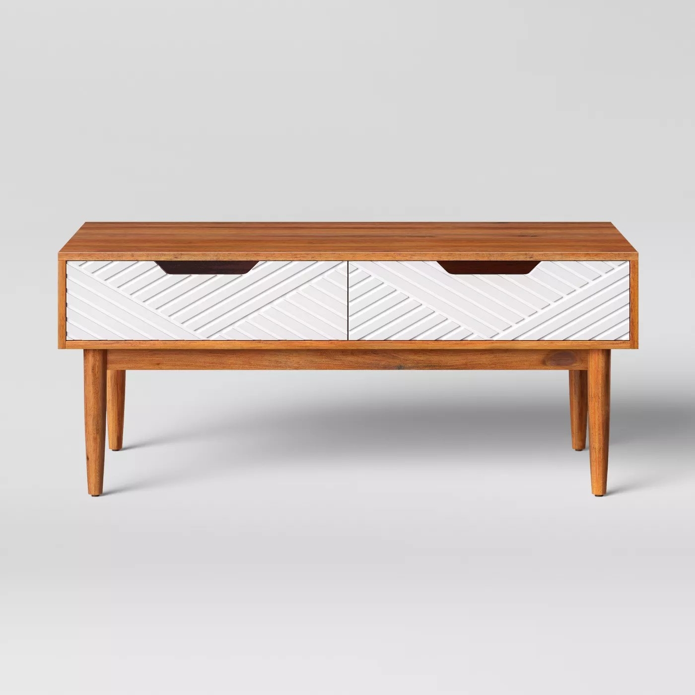 The wooden coffee table with white textured drawers