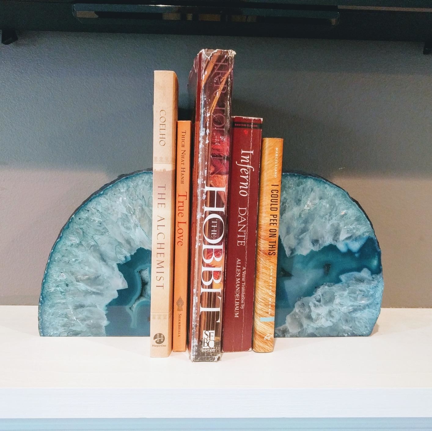 reviewer image of two light blue geode bookends holding up a few books