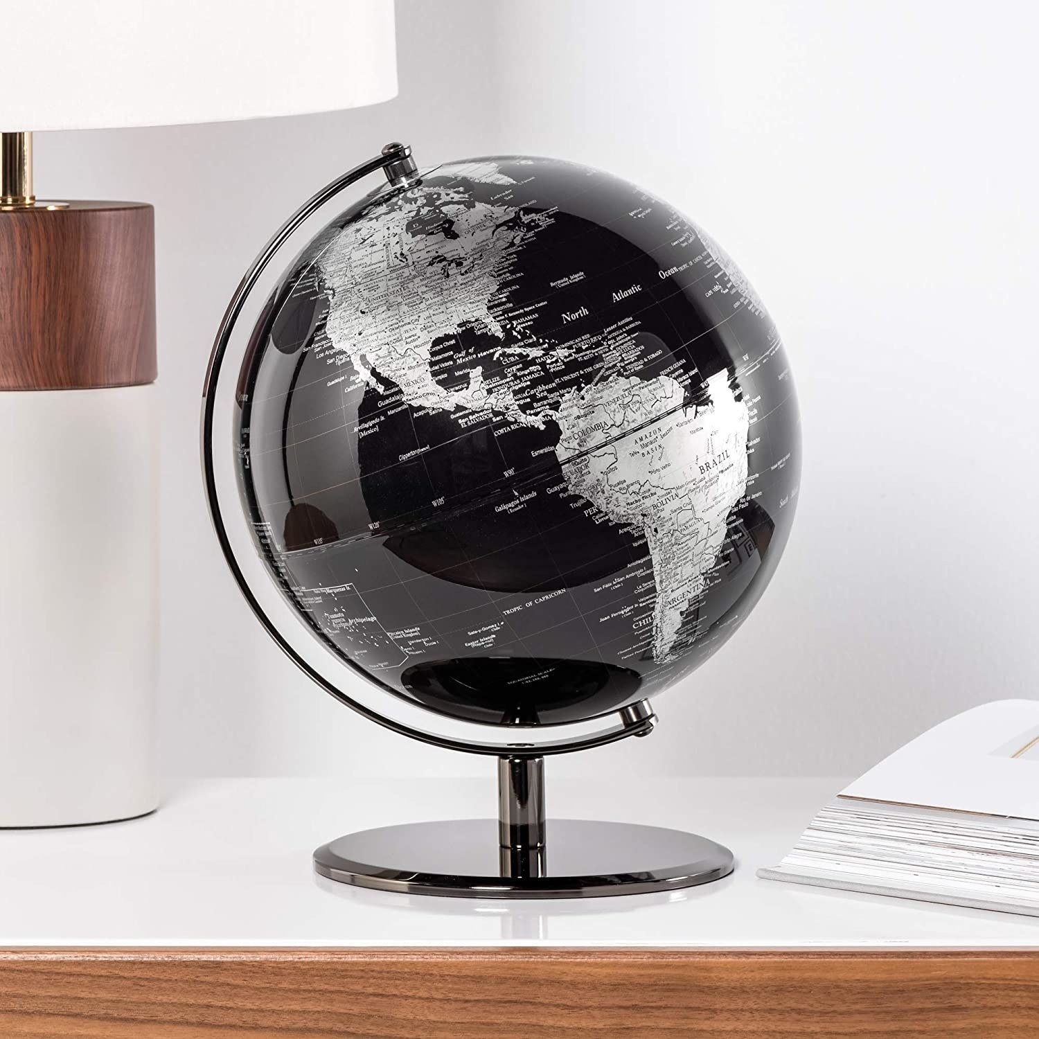 the black torre and tagus world globe on a console table