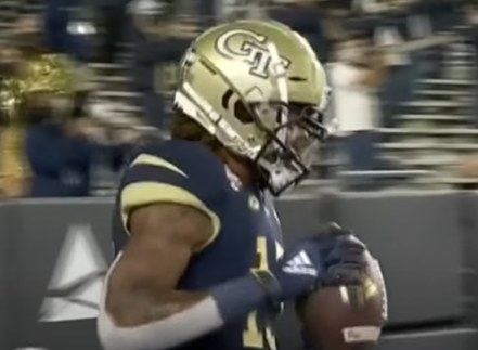 Gold helmet with white lettering of &quot;GT&quot;