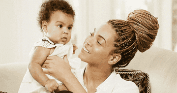 Beyonce kissing a baby Blue Ivy on her adorable cheek