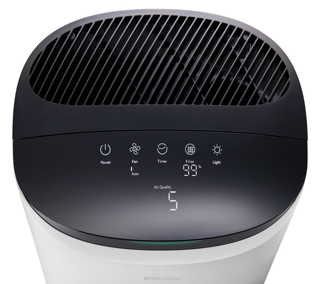 The black top of air purifier with  a digital screen and white numbers
