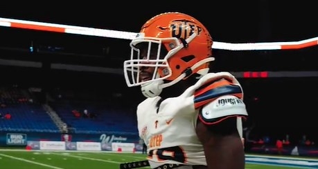 Orange helmet with blue letters &quot;UTEP&quot; and the &quot;T&quot; is a pickax.