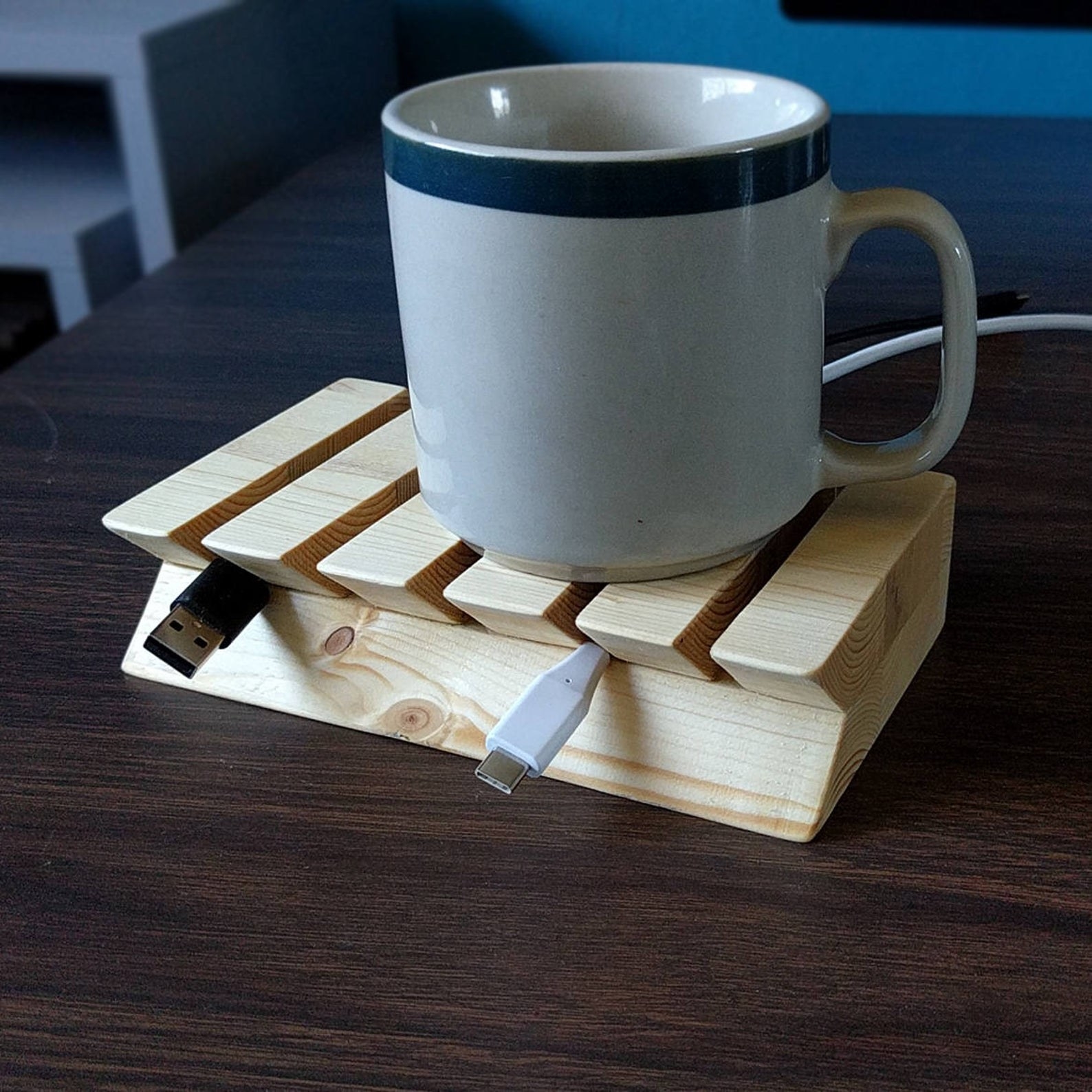 wooden cord organizer propping up phone charger cords
