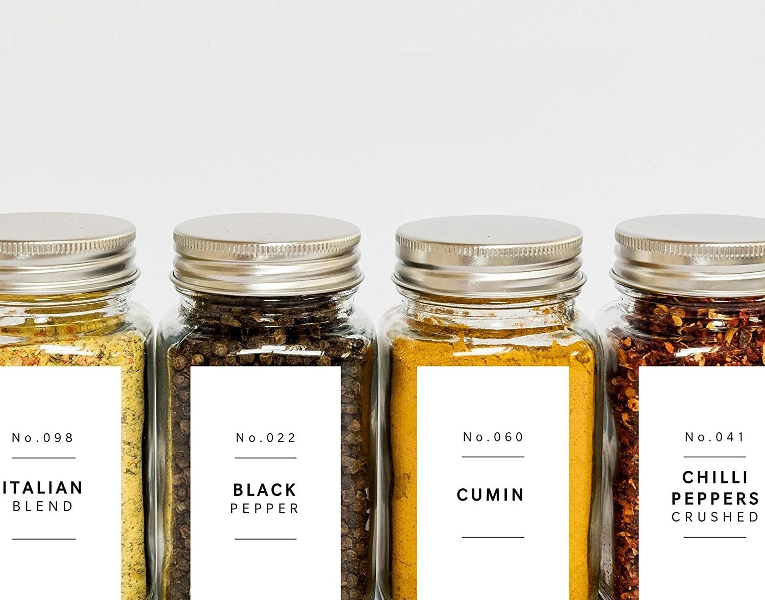 A set of spice jars with neat minimalist labels on the front