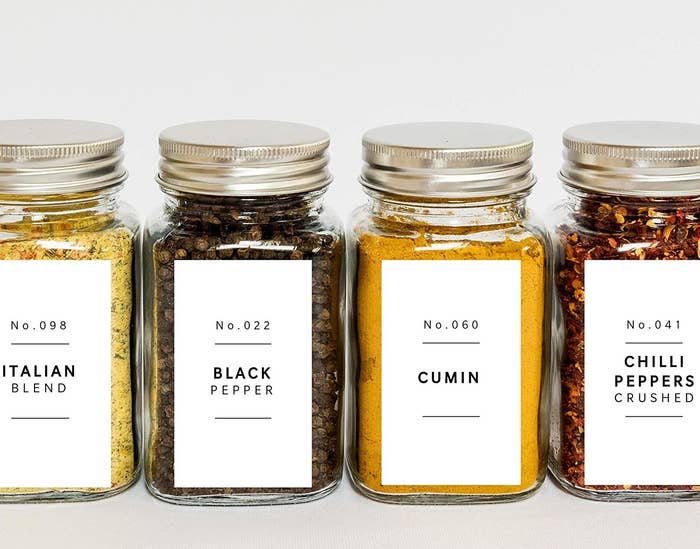 A set of spice jars with neat minimalist labels on the front