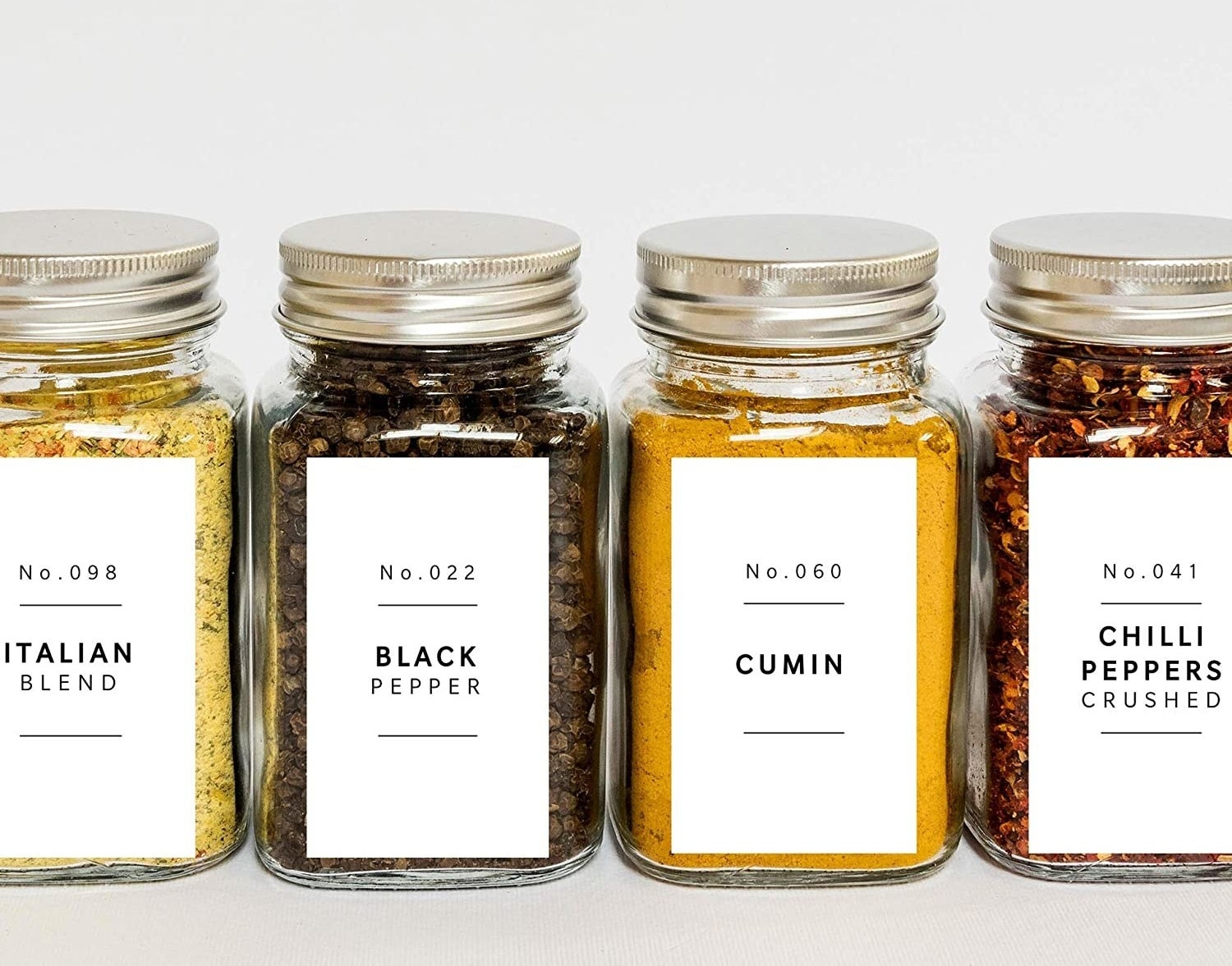 A set of spice jars with neat minimalist labels on the front