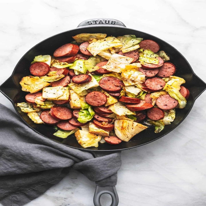 Sausage and cabbage in a cast iron skillet.