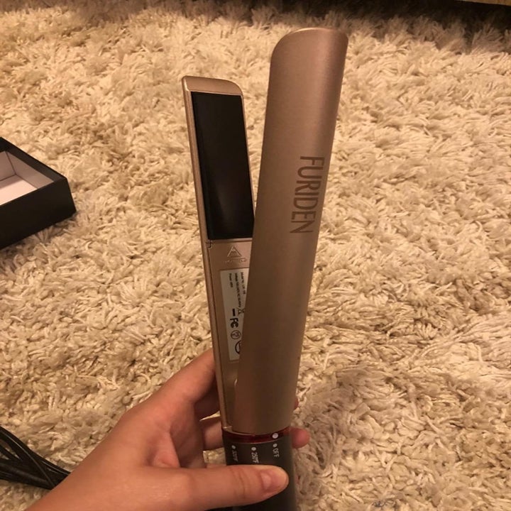 the two in one straightener and curling iron on a bathroom counter