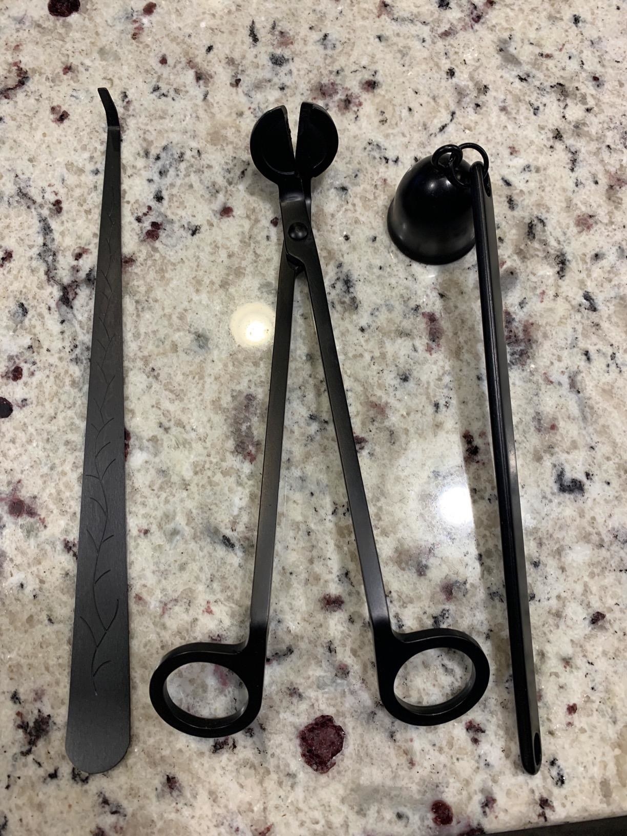 reviewer photo showing the three tools included in the candle care kit
