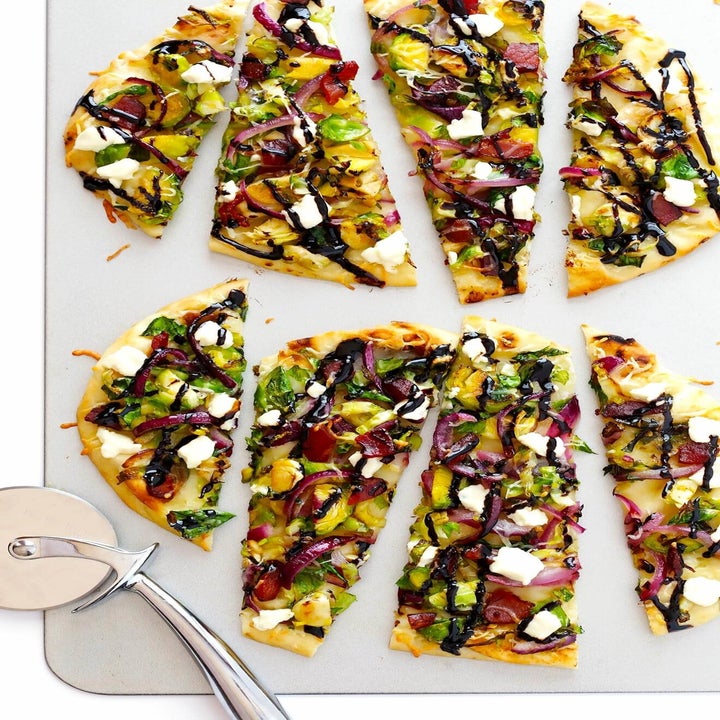 A bacon and Brussels sprouts flatbread cut into slices.