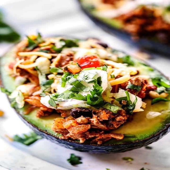 An avocado stuffed with taco filling.