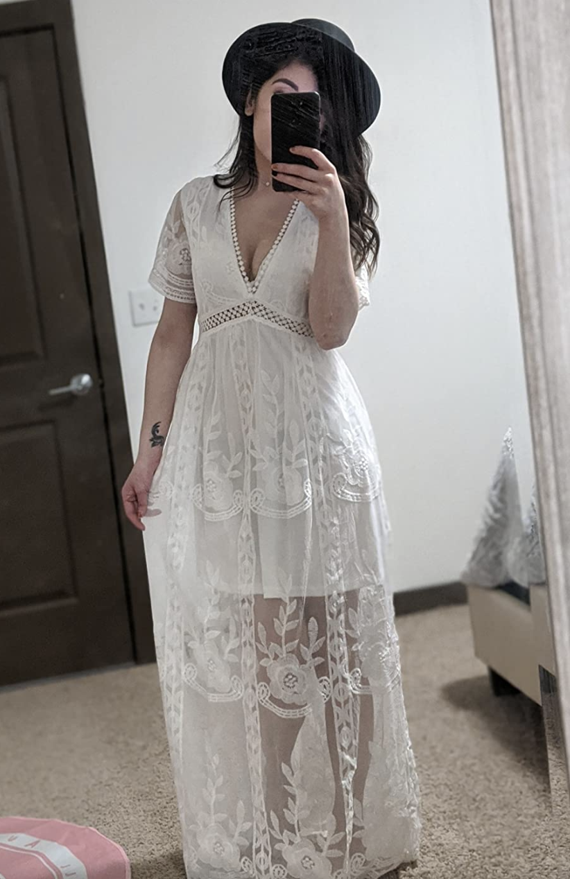 reviewer wearing the lace V-neck dress