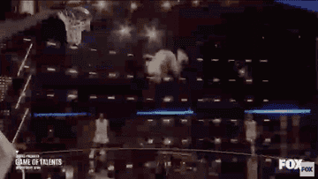 A gif of a man leaping off a trampoline to dunk a basketball