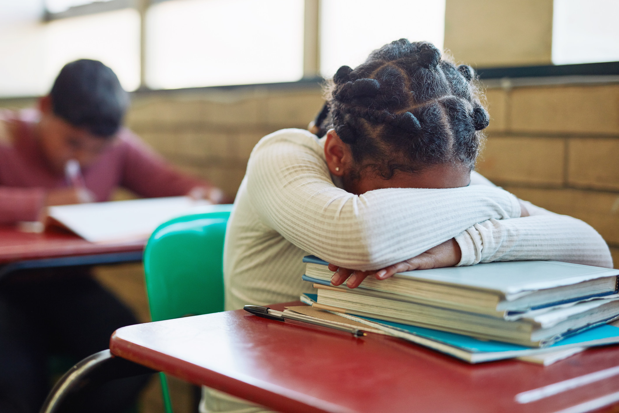 girl with her head down on her desk