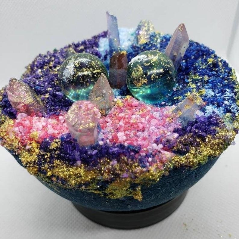 the geode-shaped bath bomb with crystals and shimmering colors on top