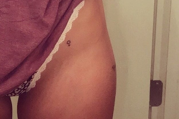 Tiny female gender symbol tattoo