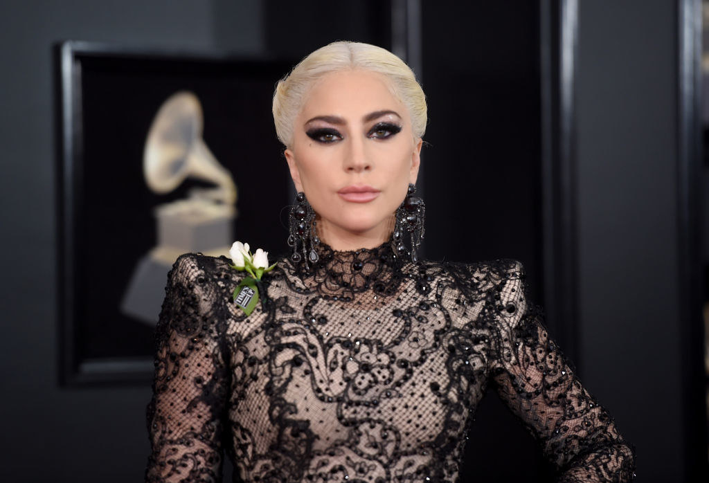 Lady Gaga wearing a high-neck lace gown with padded shoulders at the Grammys