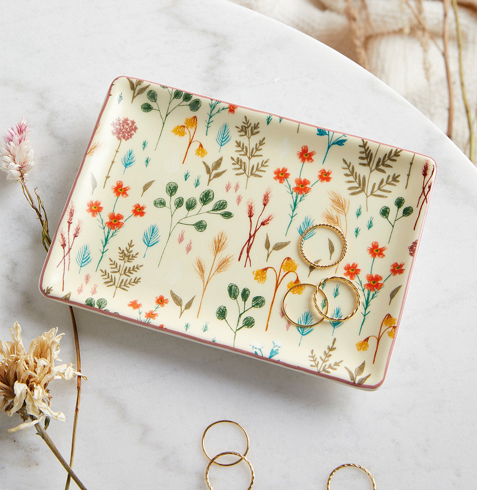 A rectangular ceramic dish with three rings on it