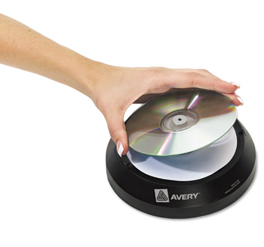 A hand putting a blank CD onto a label applicator 