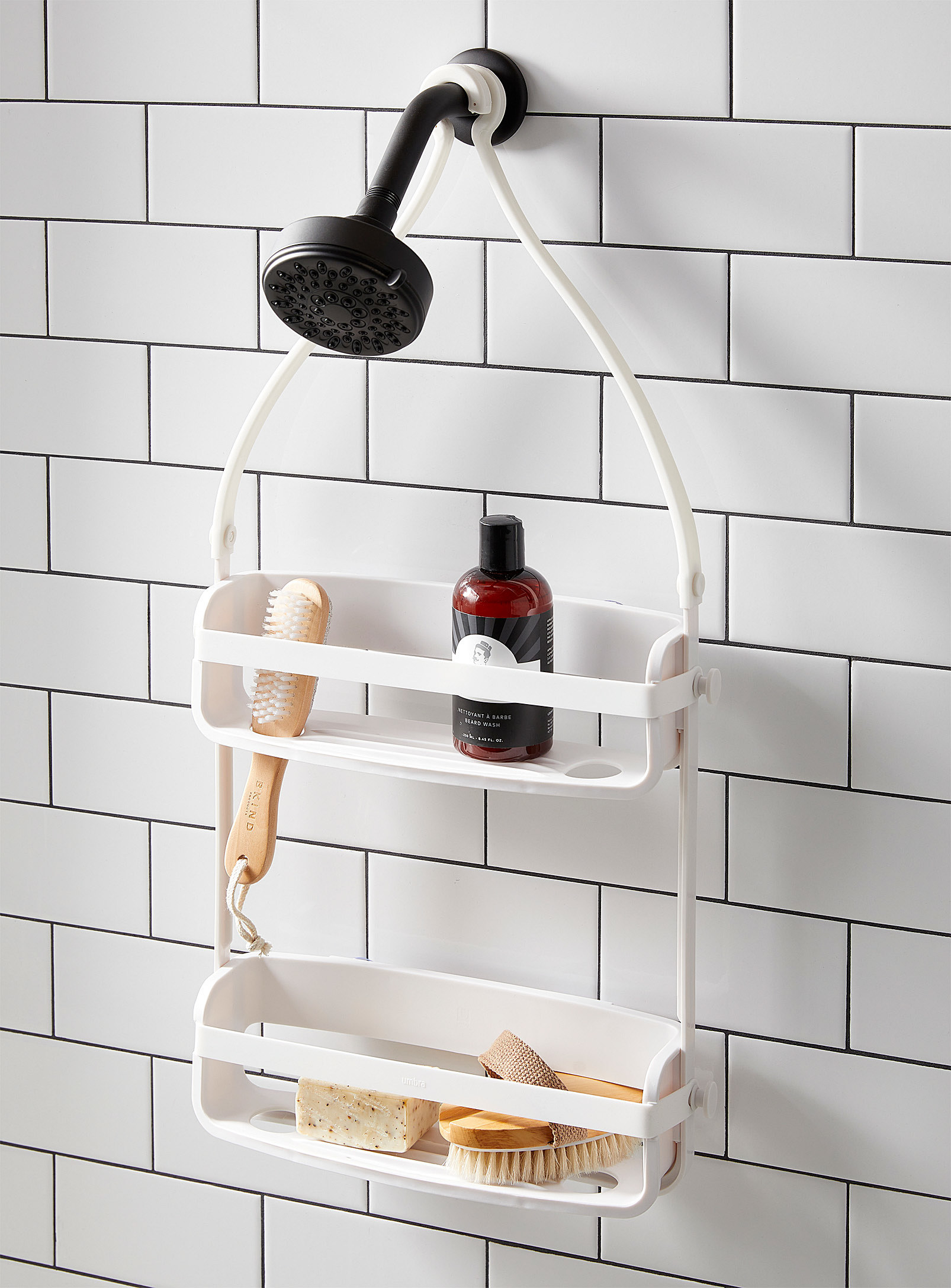 A two tiered shower caddy hanging from a shower hose