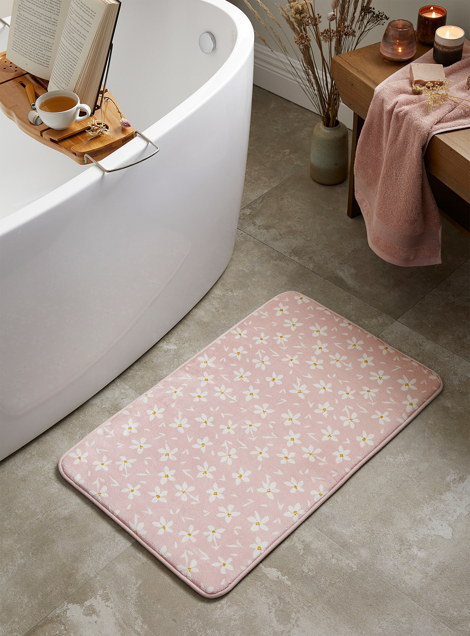 A thick bath mat next to a bathtub