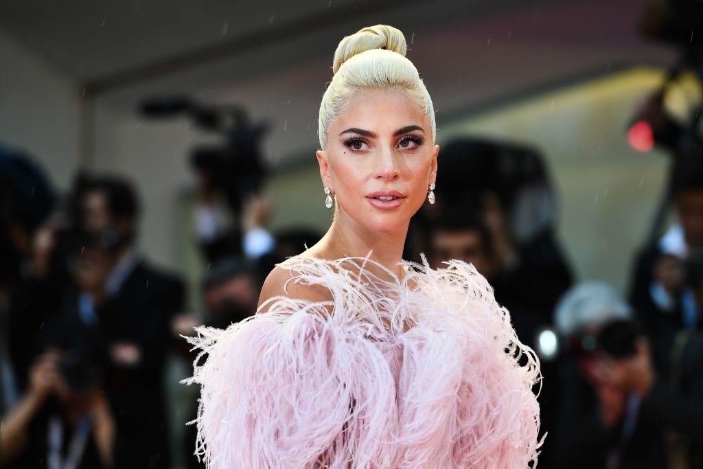 Lady Gaga posing in a feathered strapless dress
