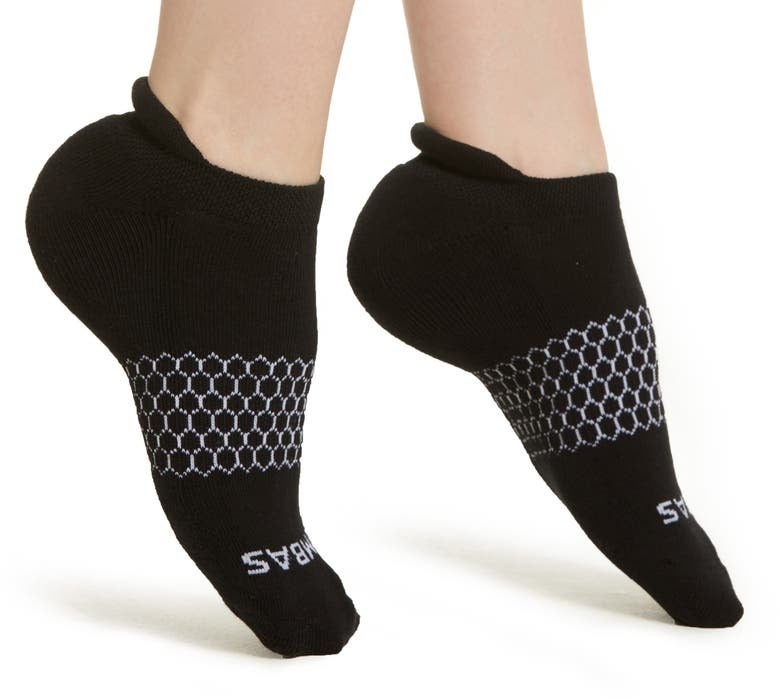 person with black bombas socks on their feet