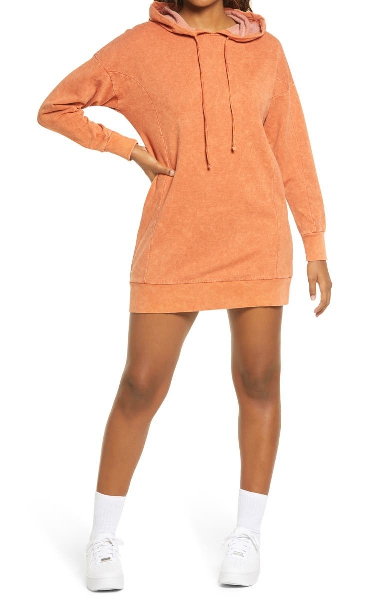 model wearing a orange sweatshirt dress