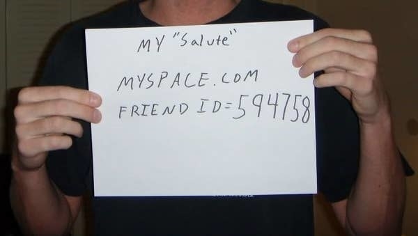 A pair of hand holding a paper with &quot;my &#x27;salute&#x27; myspace.com Friend ID = 594758&quot;
