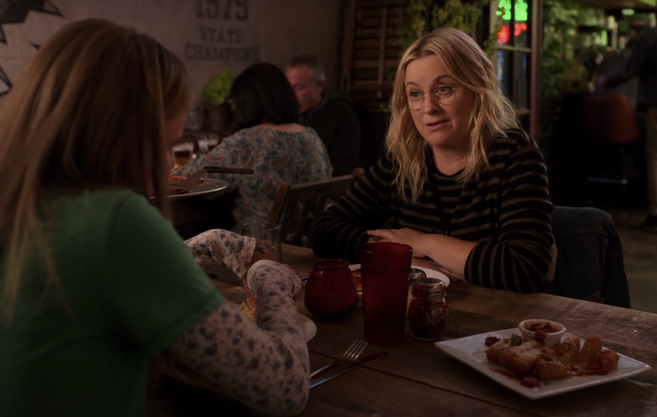 Amy sits across from her daughter in a screenshot from Moxie