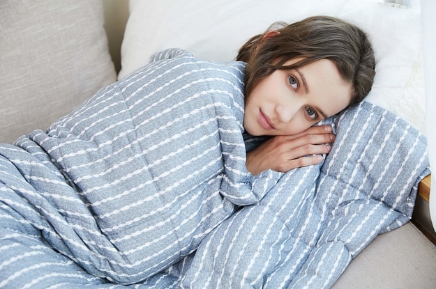 A model under the blue and white blanket