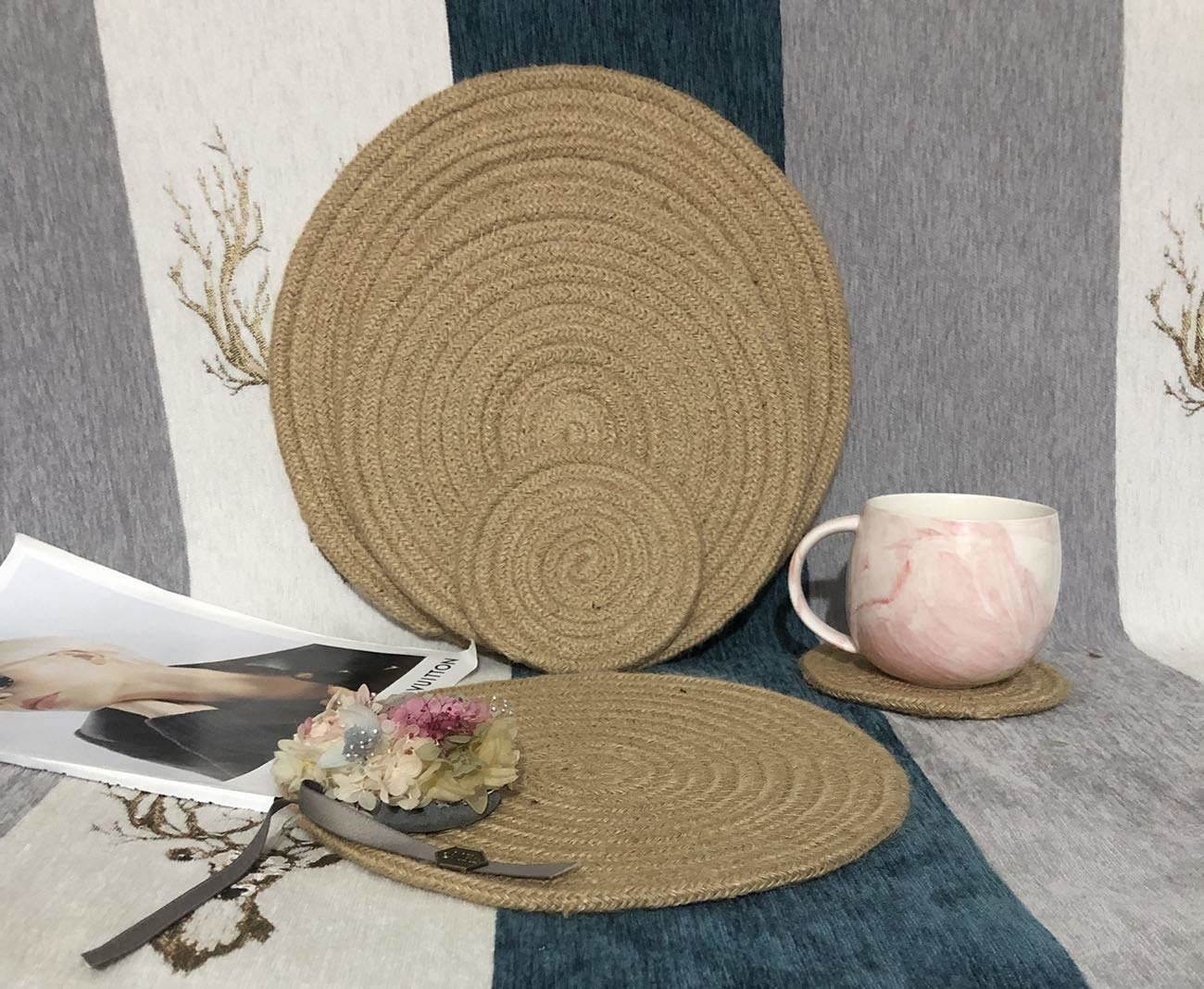 A set of jute placemats with a cup and a photograph beside them 